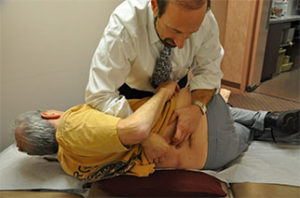 Dr. Miller giving a back treatment to a patient.