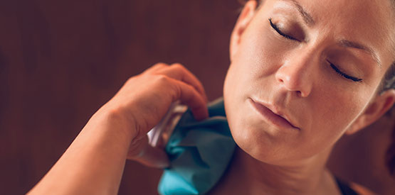 A woman using her ice pocket for treatment.