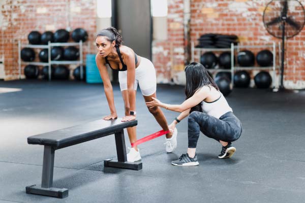 Two woman doing a leg exercise